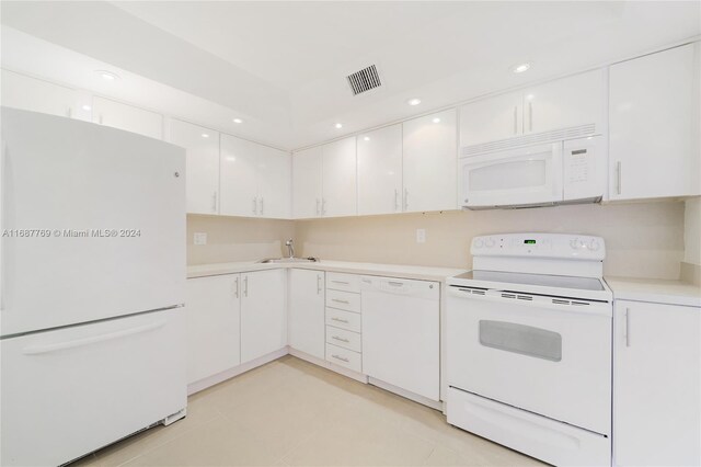210 Sea View Dr Unit 409, Key Biscayne, FL 33149 - kitchen featuring white appliances, a sink, white cabinets, light countertops, and recessed lighting