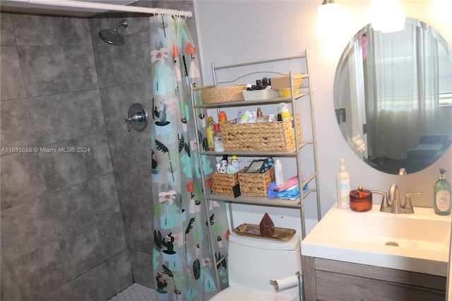 bathroom with toilet, vanity, and a shower with shower curtain