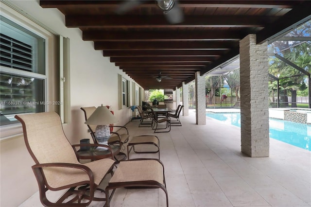 view of patio / terrace with glass enclosure and ceiling fan