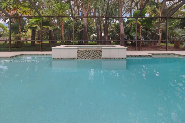 view of swimming pool with a lanai