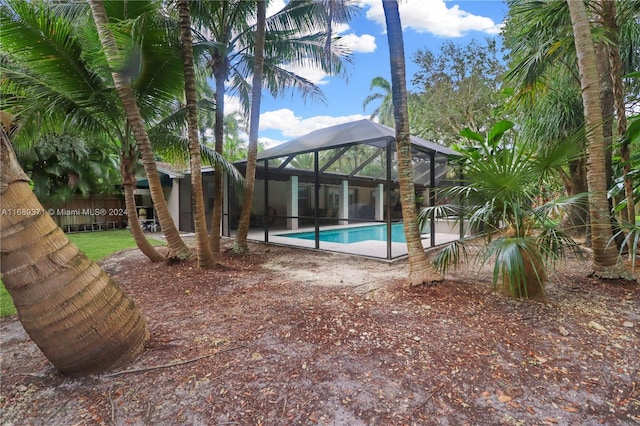 view of swimming pool featuring a lanai and a patio