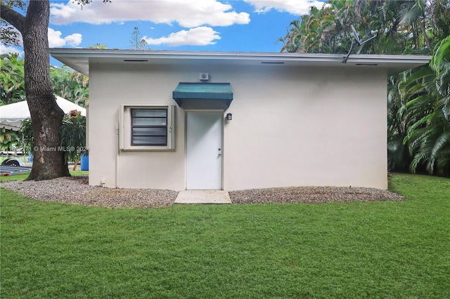 rear view of property with a lawn