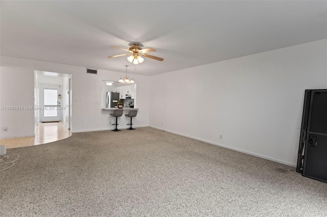 unfurnished living room with ceiling fan