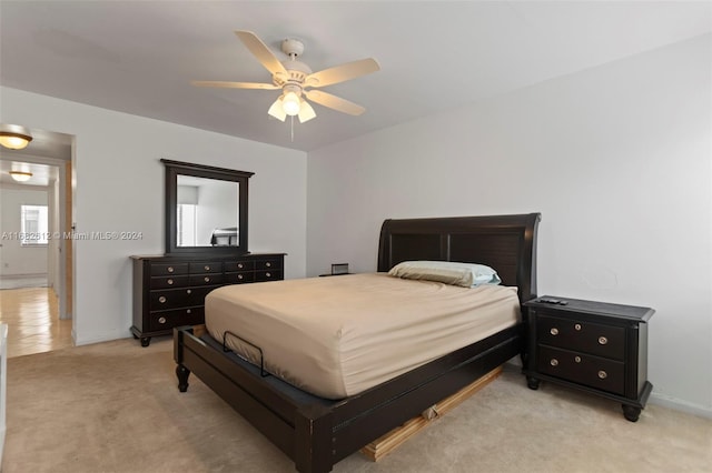 bedroom with light colored carpet and ceiling fan