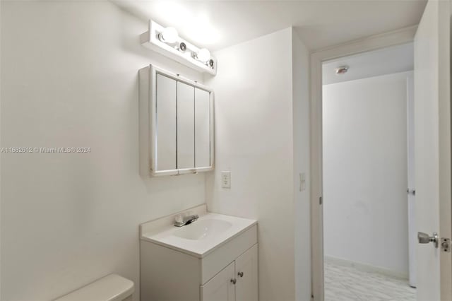 bathroom featuring toilet and vanity