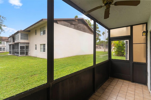 unfurnished sunroom with ceiling fan