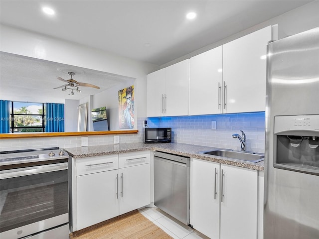 kitchen featuring ceiling fan, sink, white cabinets, and stainless steel appliances