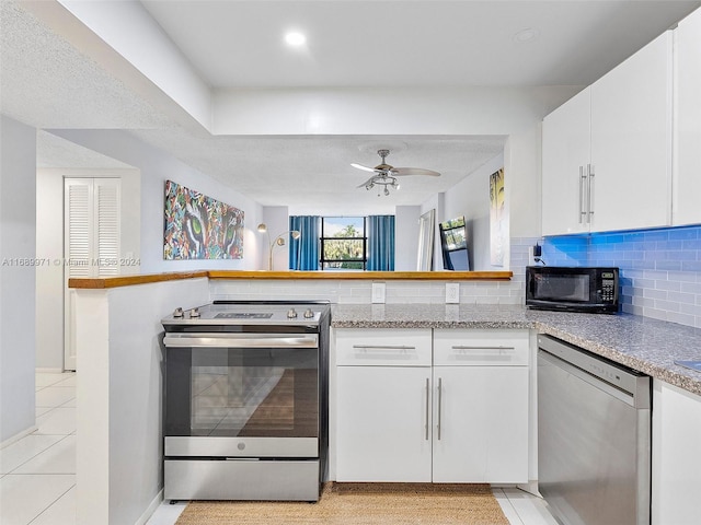 kitchen featuring kitchen peninsula, stainless steel appliances, white cabinets, and ceiling fan