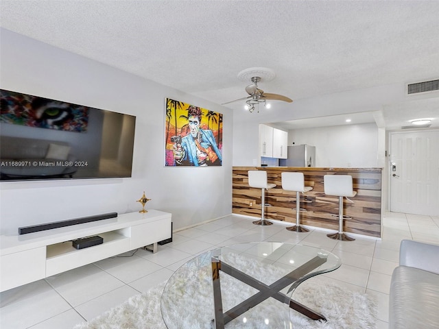 600 Parkview Dr Unit 227, Hallandale Beach, FL 33009 - living room featuring ceiling fan, light tile patterned flooring, and a textured ceiling