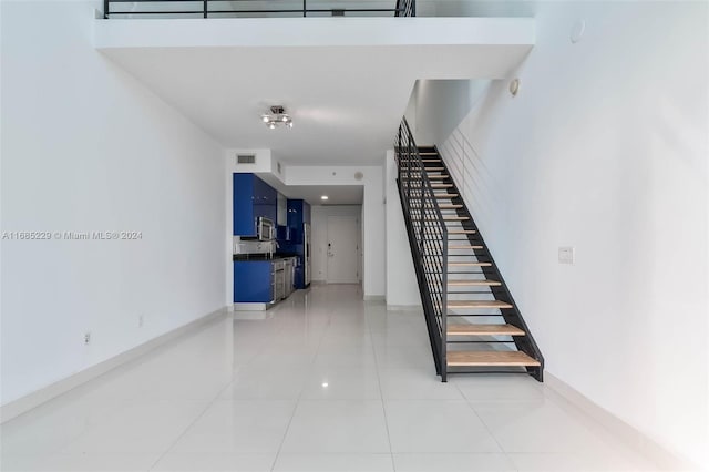 staircase with sink and tile patterned flooring