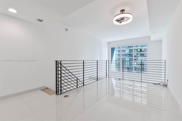 hallway with tile patterned flooring