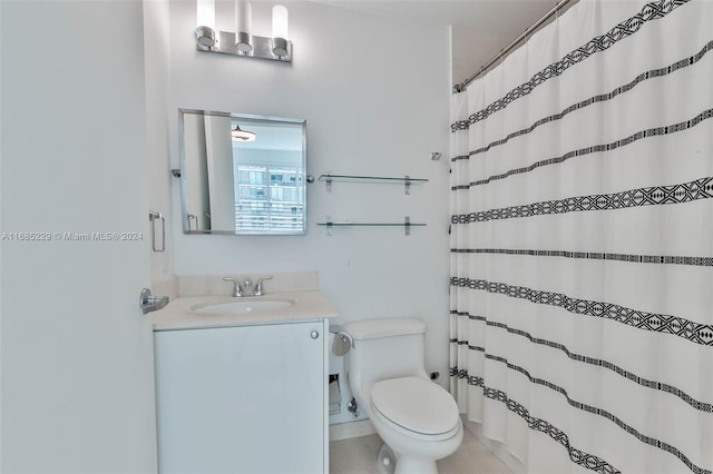 bathroom with tile patterned flooring, curtained shower, vanity, and toilet