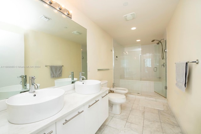 bathroom featuring toilet, vanity, a bidet, and a shower with shower door