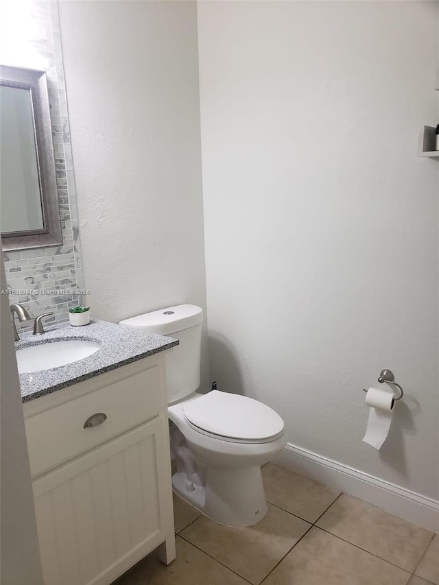 bathroom featuring vanity, tile patterned flooring, and toilet