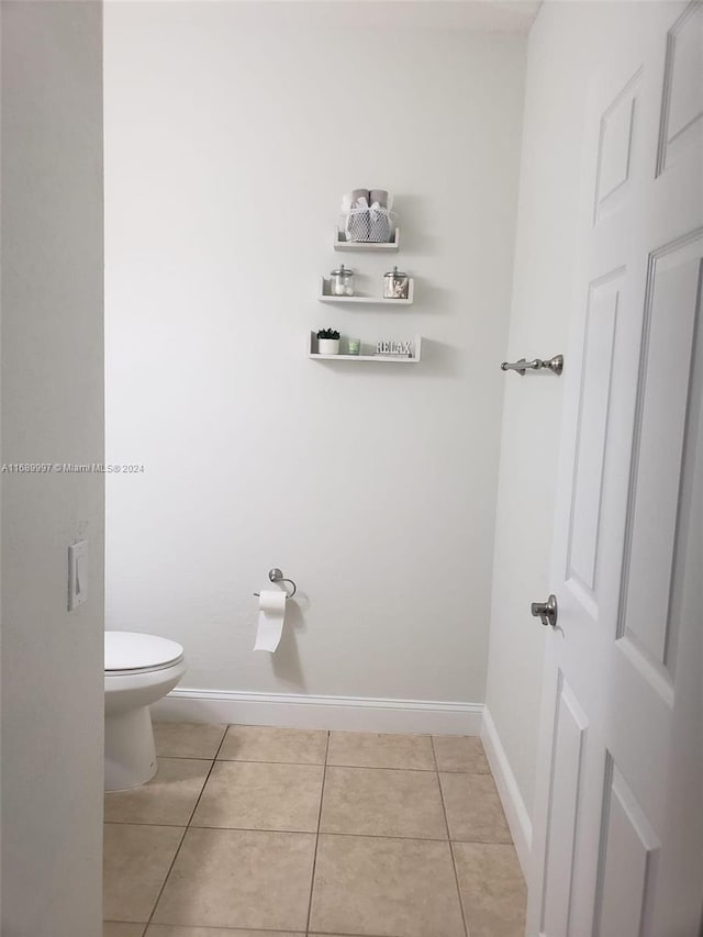 bathroom featuring tile patterned floors and toilet