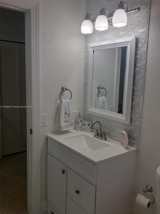 bathroom featuring vanity, tile patterned floors, and backsplash