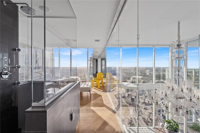 interior space with floor to ceiling windows and wood-type flooring