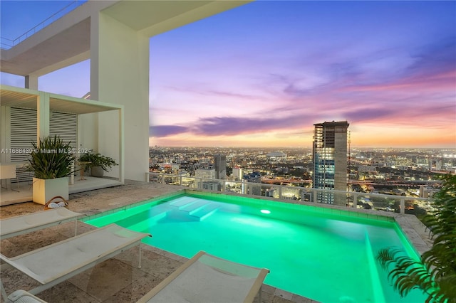 view of pool at dusk