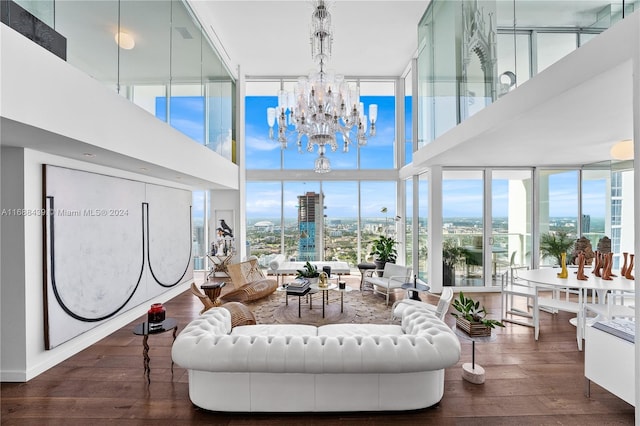 living room featuring plenty of natural light, dark hardwood / wood-style floors, and a chandelier