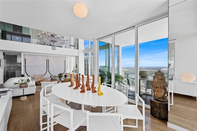 dining area featuring hardwood / wood-style floors and expansive windows