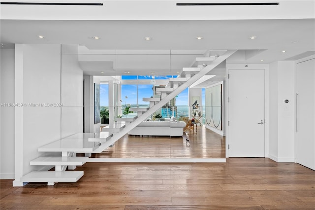 stairs featuring hardwood / wood-style floors