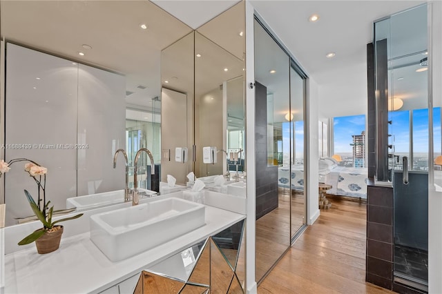 bathroom featuring hardwood / wood-style floors, a wealth of natural light, and sink