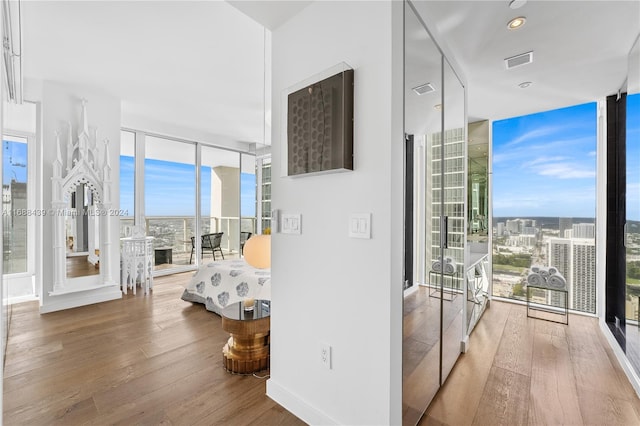 interior space featuring floor to ceiling windows and hardwood / wood-style floors