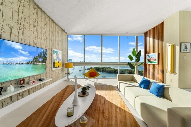 living room featuring wallpapered walls and floor to ceiling windows