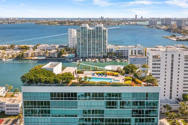 drone / aerial view featuring a view of city and a water view
