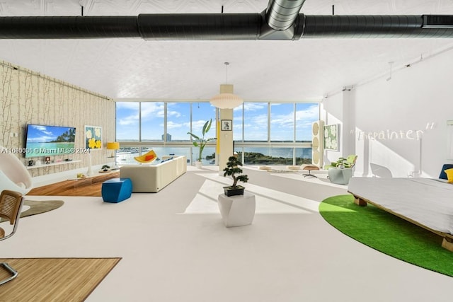 interior space with expansive windows and a water view