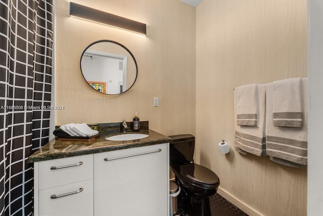 bathroom featuring vanity, tile patterned floors, and toilet