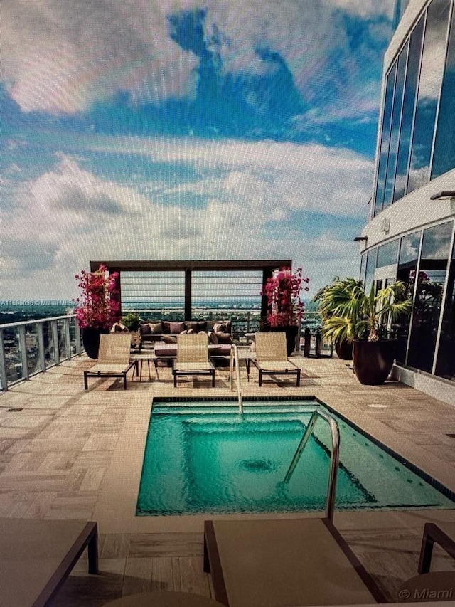 view of swimming pool featuring an outdoor living space and a patio