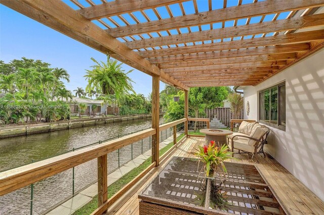 wooden terrace featuring a pergola and a fire pit