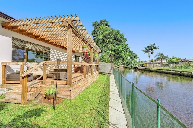 view of yard with a deck with water view and a pergola