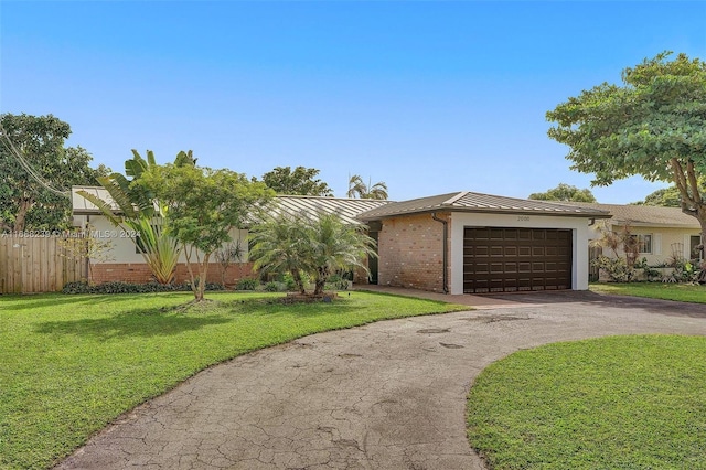 ranch-style home featuring a garage and a front lawn