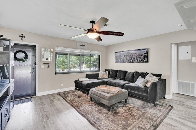 living room with ceiling fan and light hardwood / wood-style flooring