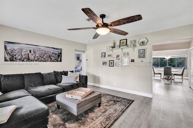 living room with hardwood / wood-style flooring and ceiling fan