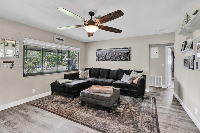 living room with hardwood / wood-style flooring and ceiling fan