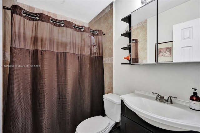 bathroom featuring toilet, vanity, and a shower with shower curtain
