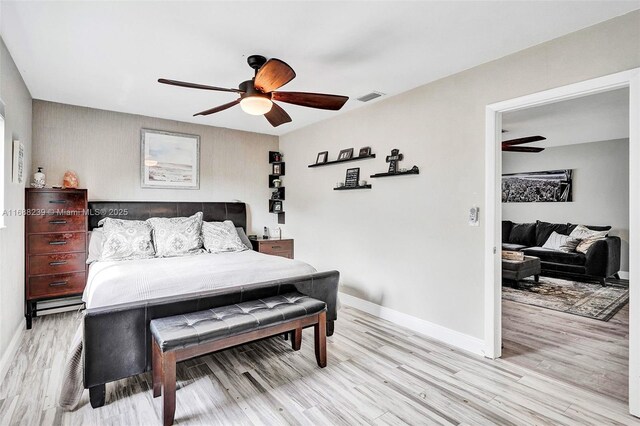 bedroom with light hardwood / wood-style floors and ceiling fan