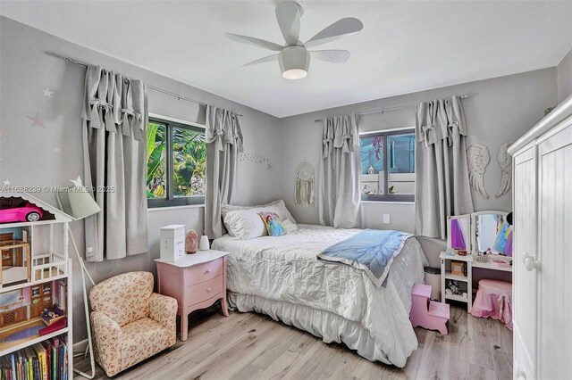 bedroom with ceiling fan and light wood-type flooring