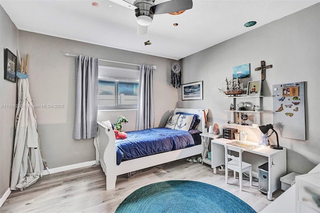 bedroom with ceiling fan and wood-type flooring