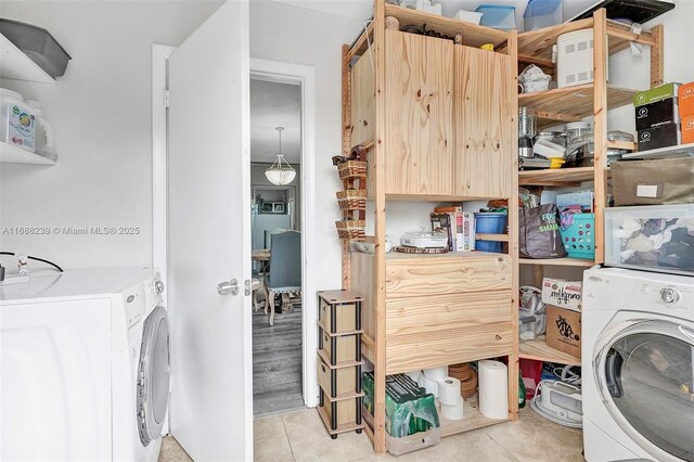 washroom with washer / clothes dryer and light tile patterned floors