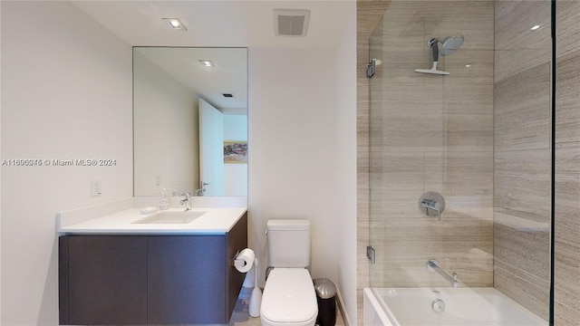 full bathroom featuring tiled shower / bath, toilet, and vanity