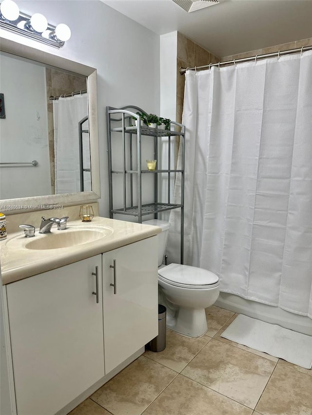 bathroom featuring a shower with curtain, tile patterned flooring, vanity, and toilet