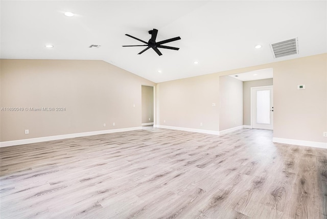 spare room with ceiling fan, light wood-type flooring, and vaulted ceiling