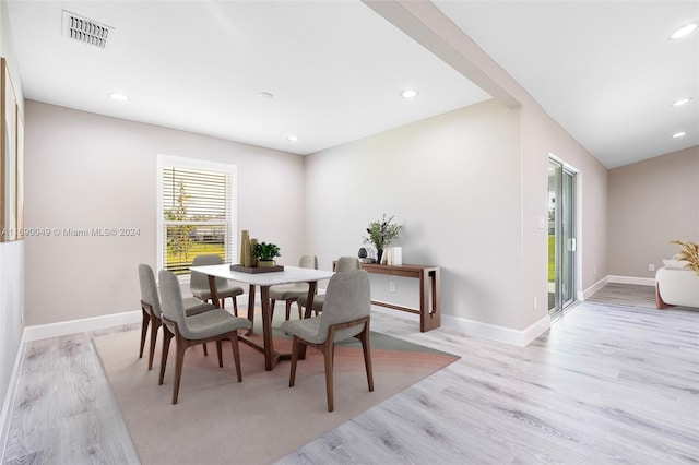 dining space with light hardwood / wood-style flooring