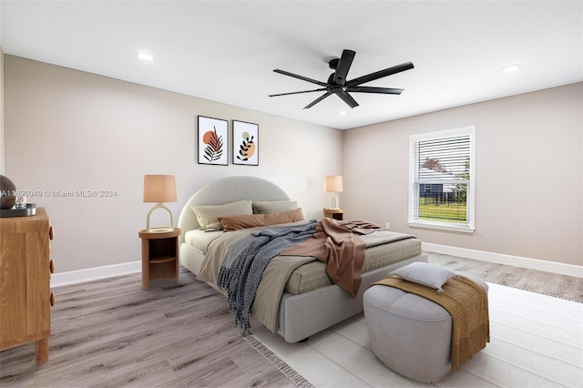 bedroom with light hardwood / wood-style floors and ceiling fan