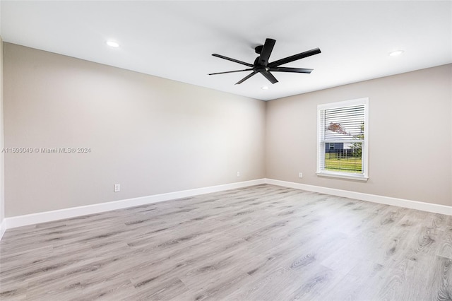 empty room with light hardwood / wood-style floors and ceiling fan