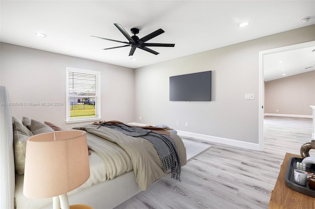 bedroom with light hardwood / wood-style flooring and ceiling fan